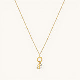Nadare Co. 14k gold plated initial and mini birthstone necklace on a delicate beaded chain.
