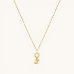 Nadare Co. gold chain necklace featuring a delicate letter a initial charm and a small sparkling birthstone pendant