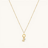 Nadare Co. gold chain necklace featuring a delicate letter a initial charm and a small sparkling birthstone pendant