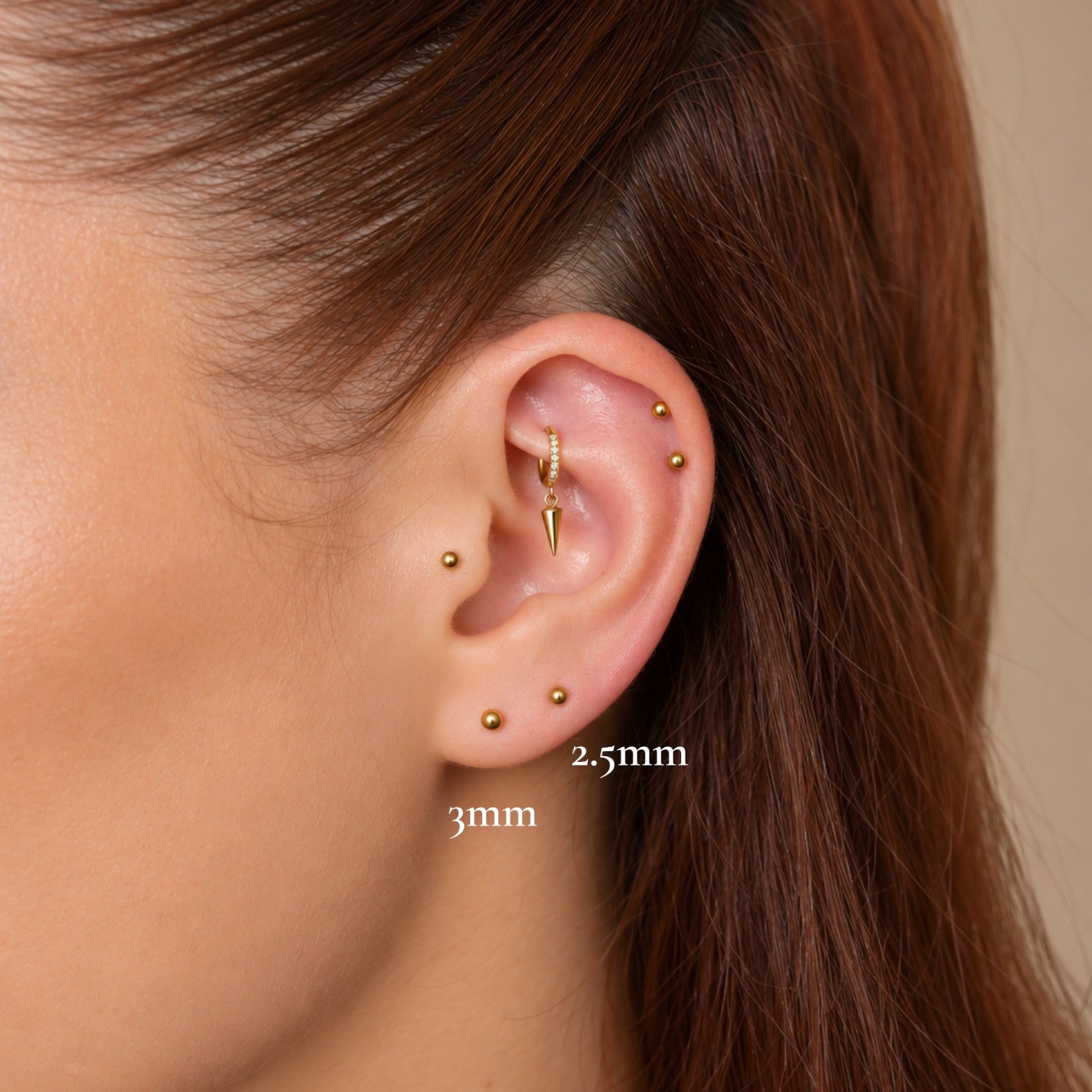 Nadare Co. Iris Threadless Front gold titanium bead piercing jewelry worn in a curated ear stack