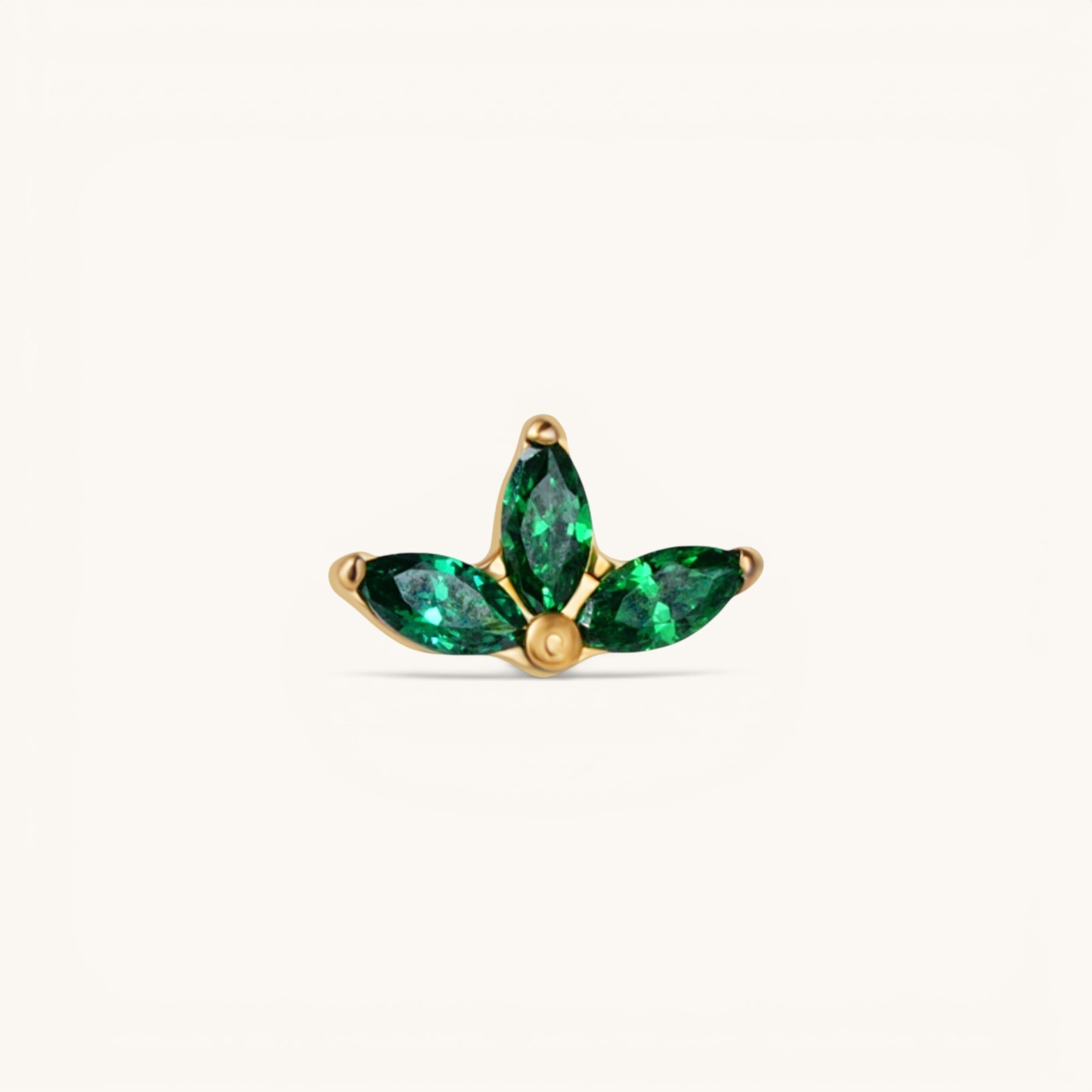 Nadare Co. Ivy threadless piercing front with three marquise-cut emerald green cubic zirconia stones in gold plating.
