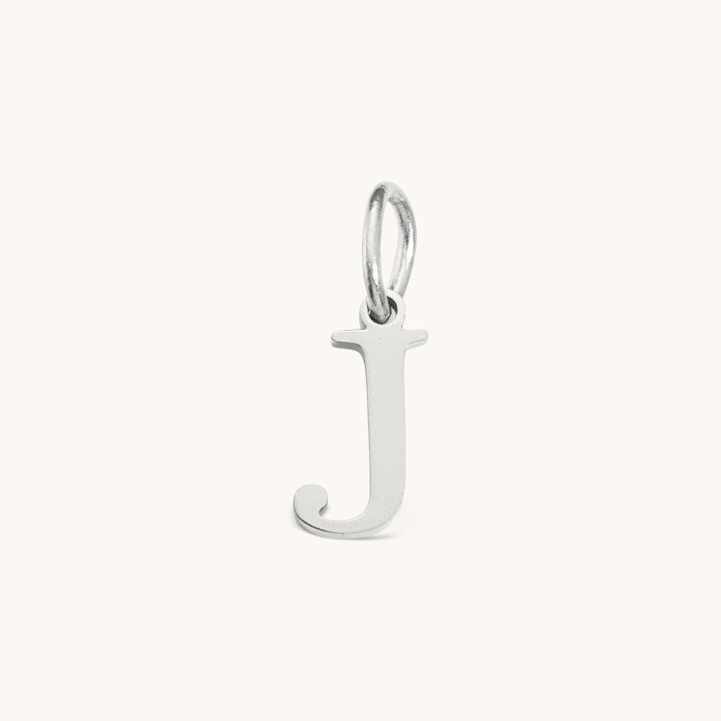 Nadare Co. silver-toned initial J charm with a clean serif font, perfect for everyday layering.