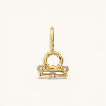 Nadare Co. gold-plated Libra zodiac charm featuring cubic zirconia accents on a stainless steel base.