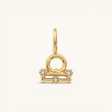 Nadare Co. gold-plated Libra zodiac charm featuring cubic zirconia accents on a stainless steel base.