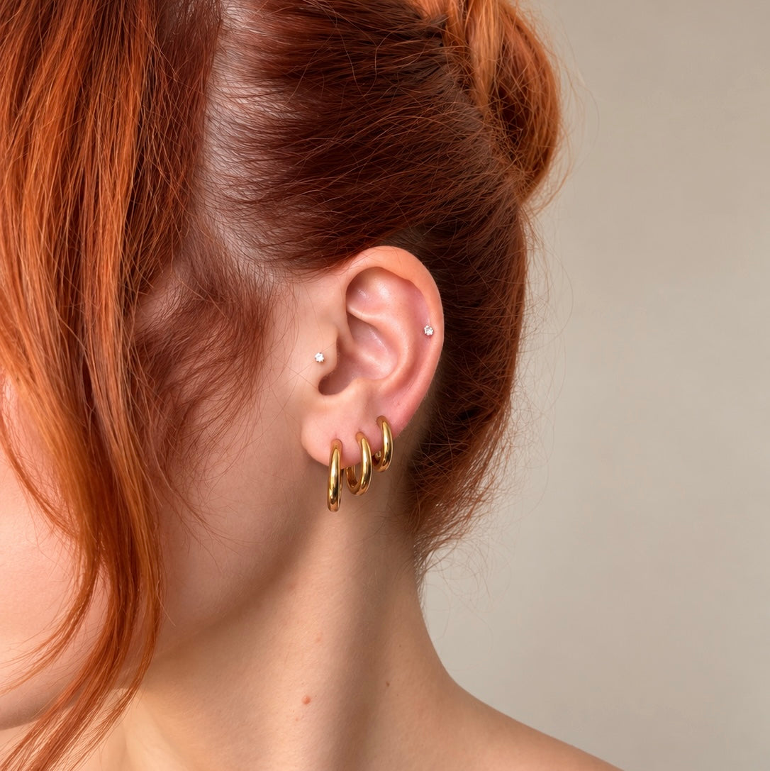 Nadare Co. Lola Hoops featuring a polished gold finish worn in a stacked ear piercing style.