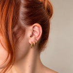 Nadare Co. Lola Hoops featuring a polished gold finish worn in a stacked ear piercing style.