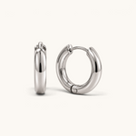 Nadare Co. Lola Hoops in polished silver stainless steel with a classic rounded silhouette and hinged closure.