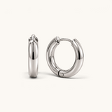 Nadare Co. Lola Hoops in polished silver stainless steel with a classic rounded silhouette and hinged closure.