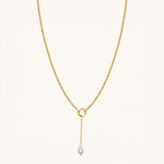 Nadare Co. long pearl drop charm on a gold chain necklace featuring a 3cm delicate chain and freshwater pearl.