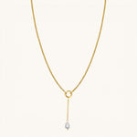 Nadare Co. long pearl drop charm on a gold chain necklace featuring a genuine freshwater pearl and 14k gold plating.