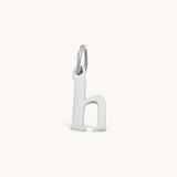 Nadare Co. lower case letter h charm in polished silver-tone stainless steel for everyday layering.