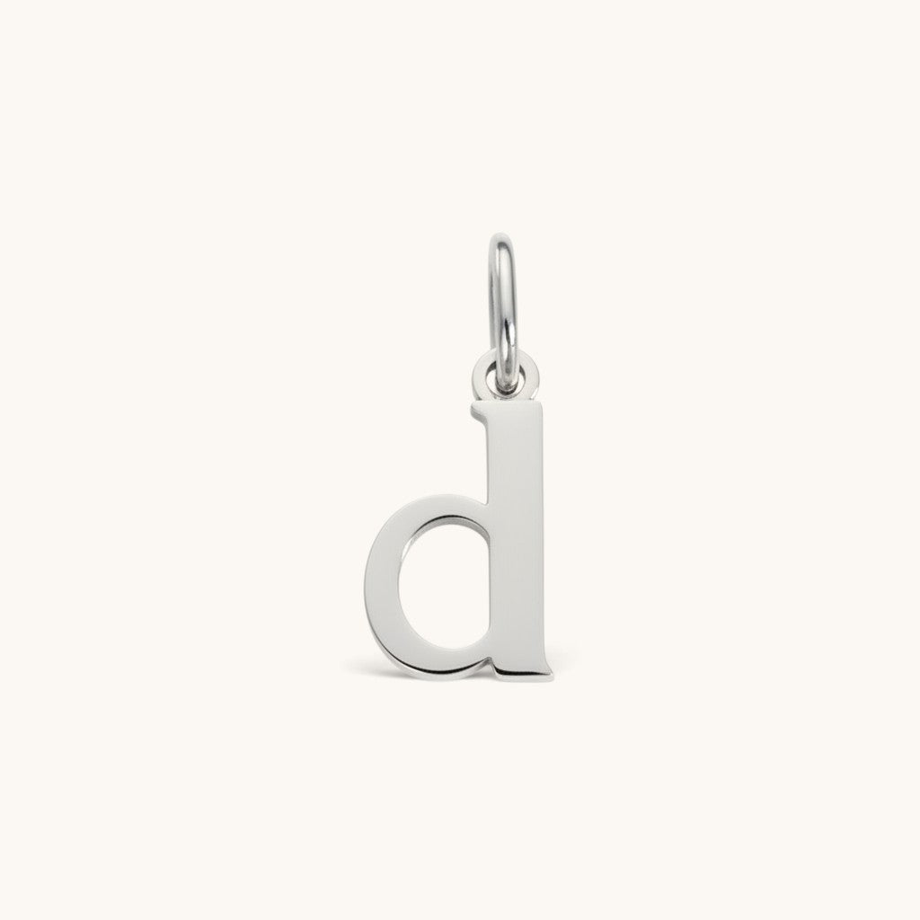 Nadare Co. silver-toned lowercase letter d charm made of durable stainless steel for everyday jewelry layering
