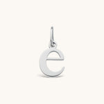 Nadare Co. lowercase letter e charm in polished silver-tone stainless steel for everyday layering.