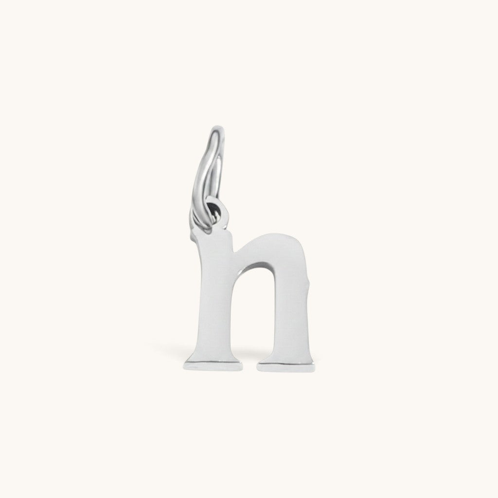 Nadare Co. silver-toned lowercase letter h charm made of stainless steel for everyday jewelry layering.