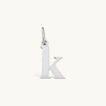 Nadare Co. lowercase letter k charm in silver-tone stainless steel for everyday jewelry layering.
