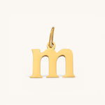 Nadare Co. lowercase letter m charm in 14k gold-plated stainless steel with a polished finish