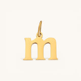 Nadare Co. lowercase letter m charm in 14k gold-plated stainless steel with a polished finish