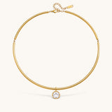 Nadare Co. Margot gold collar necklace with a polished chain and a single bezel-set round crystal pendant.