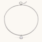 Nadare Co. Margot silver collar necklace with a polished chain and a single sparkling bezel-set round crystal pendant.