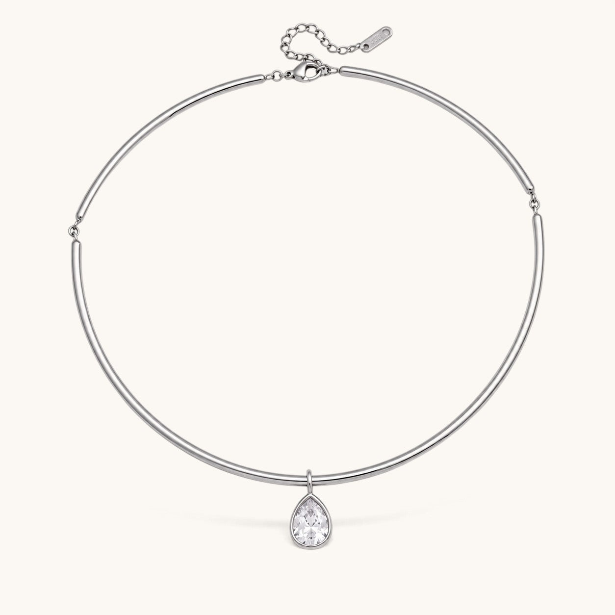 Nadare Co. Margot silver collar necklace with a pear-shaped bezel-set crystal pendant on a polished chain