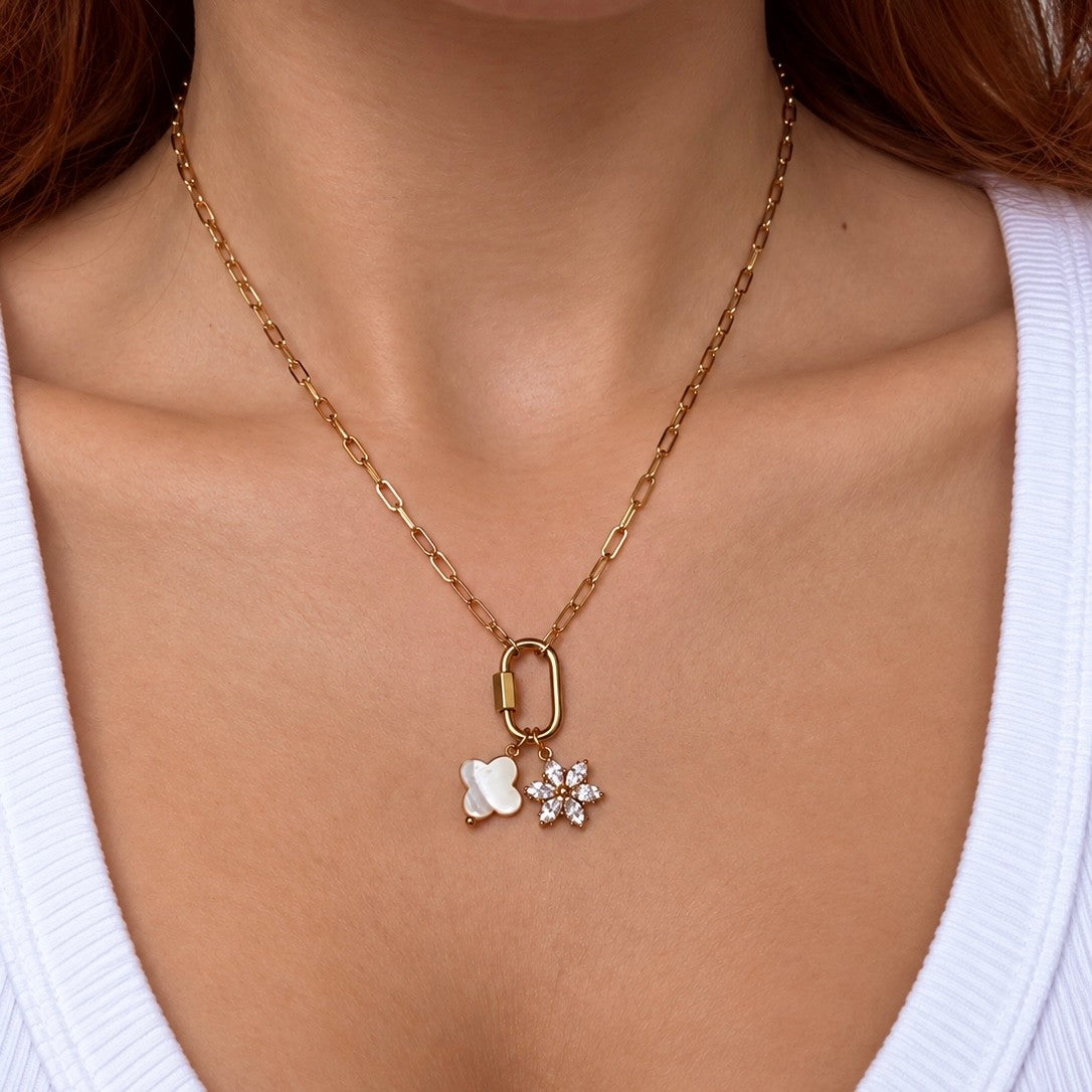 Nadare Co. gold chain necklace featuring a marquise flower charm with cubic zirconia and a white floral pendant.