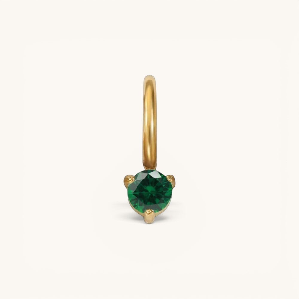 Nadare Co. mini gold birthstone charm featuring a round-cut emerald green gemstone in a delicate prong setting.