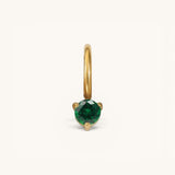 Nadare Co. mini gold birthstone charm featuring a round-cut emerald green gemstone in a delicate prong setting.