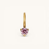 Nadare Co. mini birthstone charm featuring a round pink gemstone set in polished gold on a small hoop.