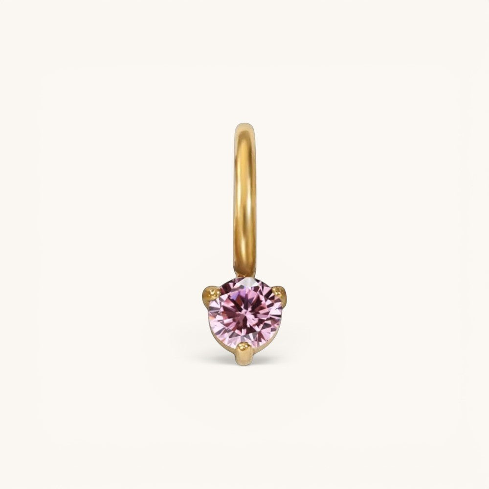 Nadare Co. mini birthstone charm featuring a round pink gemstone set in polished gold on a small hoop.