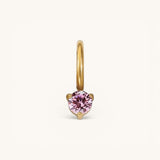 Nadare Co. mini birthstone charm featuring a round pink gemstone set in polished gold on a small hoop.