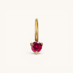 Nadare Co. mini birthstone charm featuring a round-cut vibrant red gemstone set in polished gold.