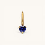 Nadare Co. mini gold hoop charm featuring a round-cut blue sapphire birthstone in a three-prong setting.