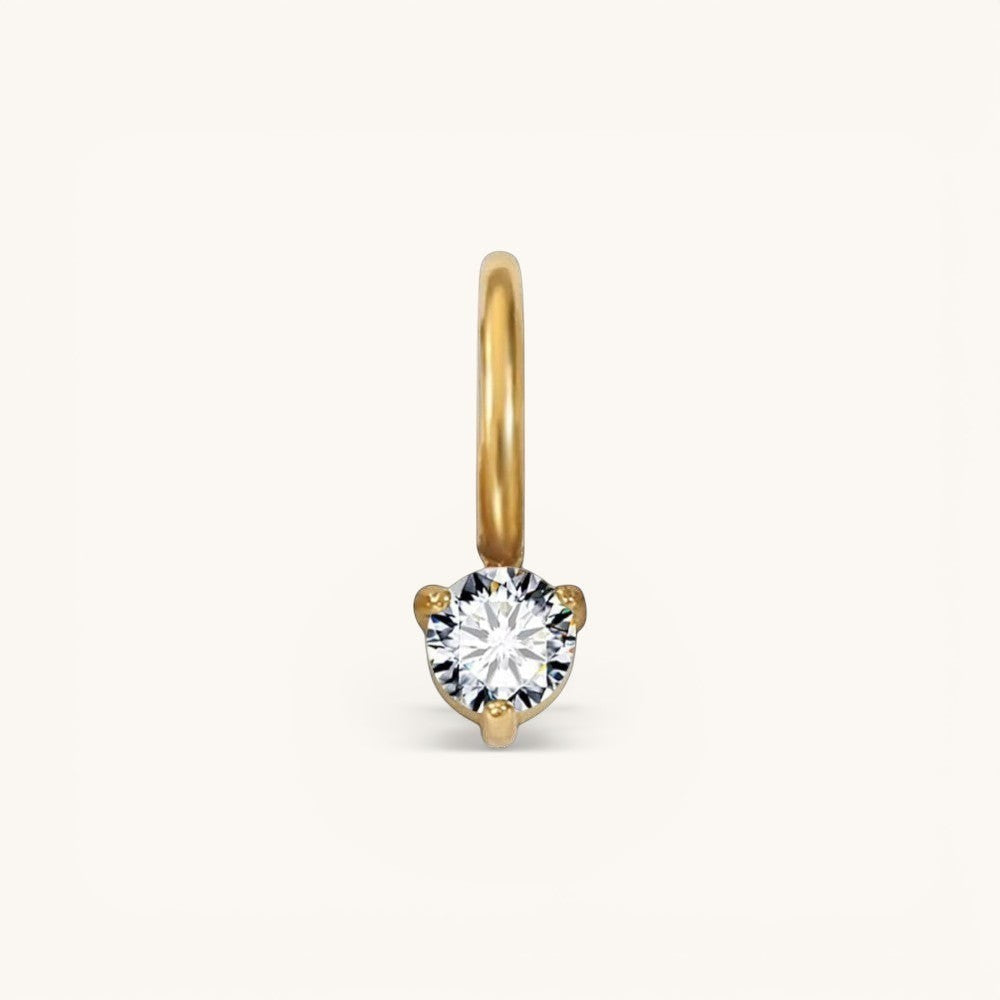 Nadare Co. mini birthstone charm featuring a round brilliant-cut white gemstone set in polished yellow gold.