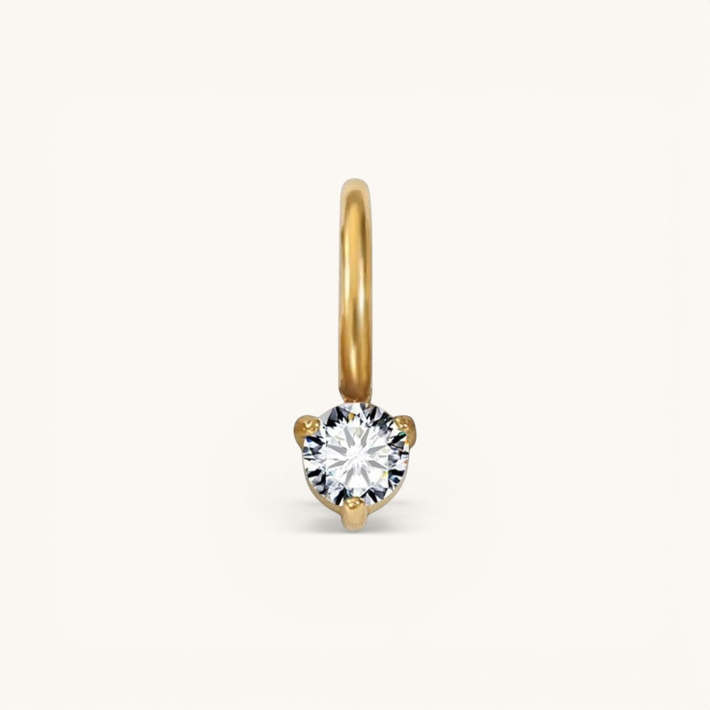 Nadare Co. mini birthstone charm featuring a round brilliant-cut white gemstone set in polished yellow gold.