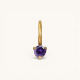 Nadare Co. mini gold hoop charm featuring a round-cut purple amethyst birthstone in a three-prong setting.