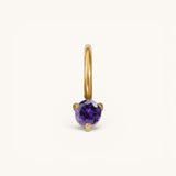 Nadare Co. mini gold hoop charm featuring a round-cut purple amethyst birthstone in a three-prong setting.
