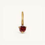 Nadare Co. mini birthstone charm featuring a round red gemstone set in polished gold on a small hoop.