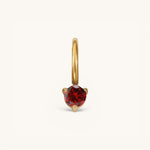 Nadare Co. mini birthstone charm featuring a round red gemstone set in polished gold on a small hoop.