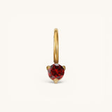 Nadare Co. mini birthstone charm featuring a round red gemstone set in polished gold on a small hoop.