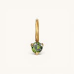 Nadare Co. mini gold birthstone charm featuring a round-cut green gemstone in a delicate prong setting.