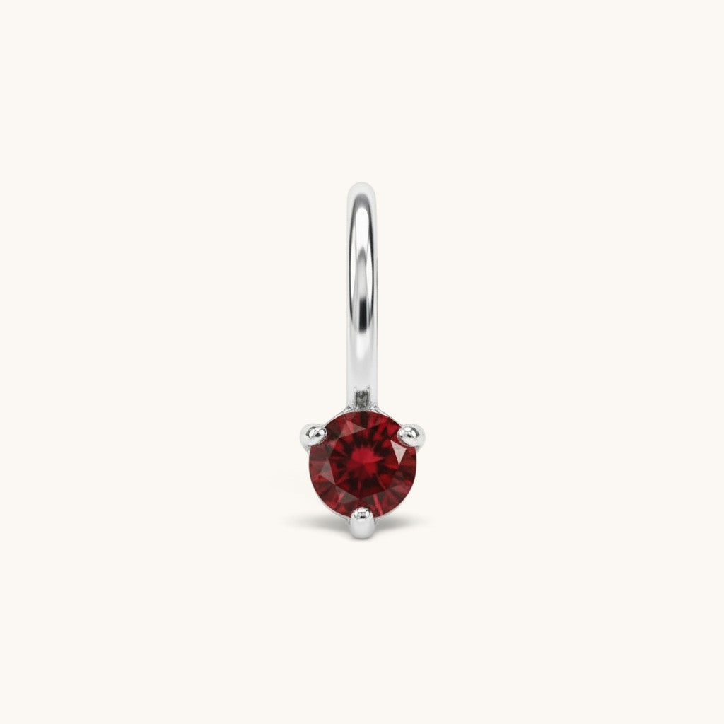 Nadare Co. mini birthstone charm featuring a round red cubic zirconia stone set in silver-toned stainless steel.