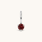 Nadare Co. mini birthstone charm featuring a round red cubic zirconia stone set in silver-toned stainless steel.