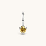 Nadare Co. mini birthstone charm featuring a round yellow cubic zirconia stone set in silver-tone stainless steel.
