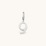 Nadare Co. number 9 charm in silver-toned stainless steel for minimalist jewelry layering.