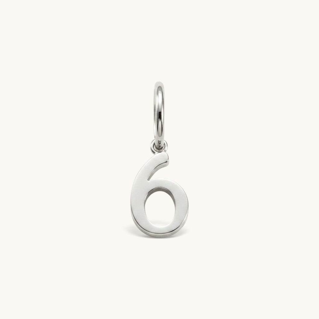 Nadare Co. silver-toned number six charm made from stainless steel for minimal everyday jewelry layering.
