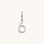 Nadare Co. silver-toned number six charm made from stainless steel for minimal everyday jewelry layering.