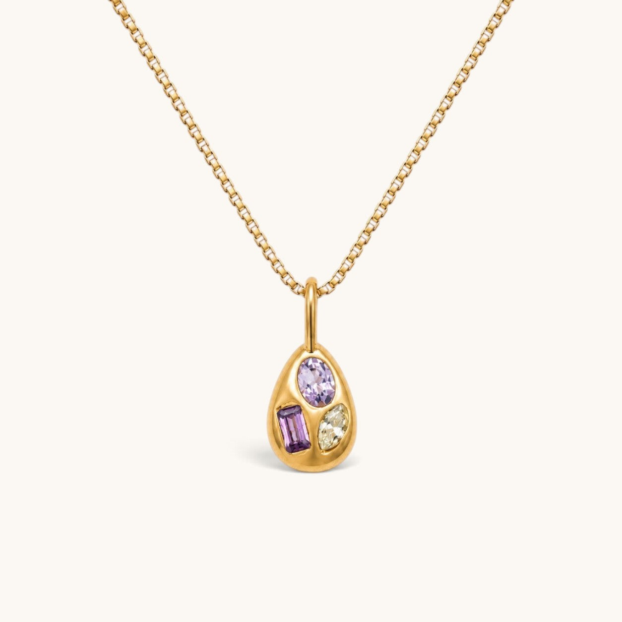 Nadare Co. Paloma Necklace featuring a gold sculptural pendant with three mismatched colorful gemstones on a box chain