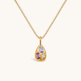 Nadare Co. Paloma Necklace featuring a gold sculptural pendant with three mismatched colorful gemstones on a box chain