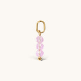 Nadare Co. birth month bead charm featuring three faceted pink crystals and a gold jump ring for necklace stacking.