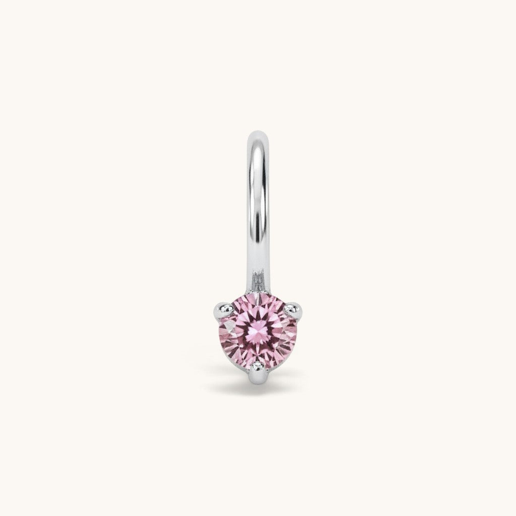 Nadare Co. mini birthstone charm featuring a round pink cubic zirconia stone set in silver-toned stainless steel.